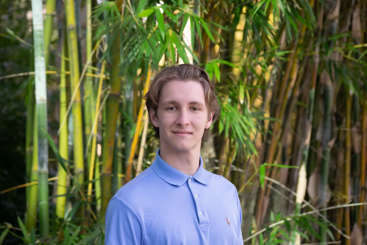 Michael Rusu outdoors in front of bamboo